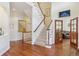 Inviting foyer with hardwood floors, staircase, and view into the living space at 4619 Mohawk Dr, Larkspur, CO 80118