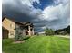 Well-manicured front yard featuring lush green lawn, professional landscaping, and beautiful home exterior at 4619 Mohawk Dr, Larkspur, CO 80118