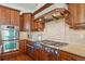 Gourmet kitchen featuring an oven, range and custom hood at 4619 Mohawk Dr, Larkspur, CO 80118