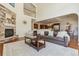Open-concept living area showcasing a fireplace, soaring ceilings, and kitchen view at 4619 Mohawk Dr, Larkspur, CO 80118