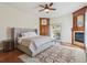 Spacious main bedroom with fireplace, wood floors, ceiling fan, and a sliding glass door to the outside at 4619 Mohawk Dr, Larkspur, CO 80118