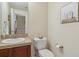Classic powder room features granite countertop and a stylish sink area for guests at 4619 Mohawk Dr, Larkspur, CO 80118