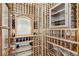 A custom wine cellar showcasing elegant wooden racking and temperature control features at 4619 Mohawk Dr, Larkspur, CO 80118