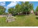 A backyard featuring a wooden play structure and expansive lawn at 12671 Meadow Bridge Way, Parker, CO 80134