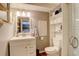 Bathroom vanity with a mirror, storage, and an adjacent toilet at 12671 Meadow Bridge Way, Parker, CO 80134