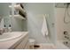 Light and bright bathroom with shower/tub, floating shelves, and white tile at 12671 Meadow Bridge Way, Parker, CO 80134