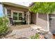Inviting front porch with stone accents, rocking chairs, and decorative plants at 12671 Meadow Bridge Way, Parker, CO 80134