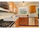 Functional kitchen with stainless steel appliances, light wood cabinets, and ample counter space at 12671 Meadow Bridge Way, Parker, CO 80134