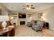 Inviting living room with a fireplace, flat screen television, ceiling fan and comfortable seating at 12671 Meadow Bridge Way, Parker, CO 80134
