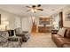 Spacious living room with comfortable seating, a ceiling fan, and natural light at 12671 Meadow Bridge Way, Parker, CO 80134