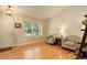 Bright living room with hardwood floors, large window, and comfortable seating area at 12671 Meadow Bridge Way, Parker, CO 80134
