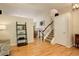 Open-concept space featuring hardwood floors, stairs, and views of dining and seating areas at 12671 Meadow Bridge Way, Parker, CO 80134