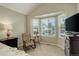 Bright bedroom featuring a bay window, comfortable seating and a dark wood dresser at 12671 Meadow Bridge Way, Parker, CO 80134