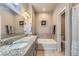 Luxurious bathroom features double sinks, soaking tub, and elegant tile at 11250 Florence St # 22B, Commerce City, CO 80640