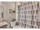 Cozy bathroom features a toilet and shower curtain with decorative art on the wall at 11250 Florence St # 22B, Commerce City, CO 80640