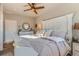 Cozy bedroom with large bed, dresser with round mirror, and abundant natural light at 11250 Florence St # 22B, Commerce City, CO 80640