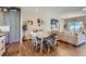 Open concept dining area with modern table, stylish chairs, and hardwood floors in neutral color palette at 11250 Florence St # 22B, Commerce City, CO 80640