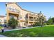 Charming townhome showcases a private balcony and is surrounded by lush green landscaping at 11250 Florence St # 22B, Commerce City, CO 80640