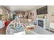Open-concept living room with fireplace, wood floors, and cozy decor throughout at 11250 Florence St # 22B, Commerce City, CO 80640