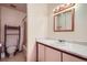 Functional bathroom featuring a shower-tub combo and a vanity with a marble-style countertop at 1002 S Miller St, Lakewood, CO 80226