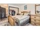 Bedroom with wood furniture, closet, and an ensuite bathroom at 1002 S Miller St, Lakewood, CO 80226