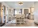 Bright dining room features stylish furnishings, natural light, and seamless flow to the kitchen and living spaces at 1002 S Miller St, Lakewood, CO 80226