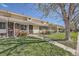 Traditional townhome featuring a brick facade, a well-maintained lawn, and a sidewalk entry at 1002 S Miller St, Lakewood, CO 80226