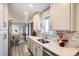 This kitchen has a double sink and an open view to the dining room at 1002 S Miller St, Lakewood, CO 80226
