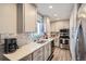 Well-equipped kitchen with stainless steel appliances, quartz countertops, and modern cabinetry for efficient meal preparation at 1002 S Miller St, Lakewood, CO 80226