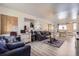 Bright living room area features nice wood flooring and large mirror at 1002 S Miller St, Lakewood, CO 80226