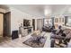 Cozy living room with stylish furnishings, wood flooring, and lots of natural light at 1002 S Miller St, Lakewood, CO 80226