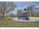 Community playground featuring colorful structures and mature trees at 1002 S Miller St, Lakewood, CO 80226