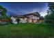 Expansive backyard offers a two-story home with patio seating and a swing set at 5611 W Bates Ave, Denver, CO 80227