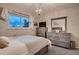 Cozy bedroom featuring a plush gray carpet, chandelier, and dresser at 5611 W Bates Ave, Denver, CO 80227