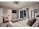Well-lit bedroom featuring plush gray carpet, chandelier, dresser and sliding glass doors at 5611 W Bates Ave, Denver, CO 80227
