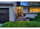 Inviting entryway with updated landscaping and exterior lighting at 5611 W Bates Ave, Denver, CO 80227