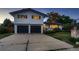 Front of home with a well-maintained lawn, a two car garage and inviting curb appeal at 5611 W Bates Ave, Denver, CO 80227