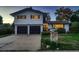 Charming two-story home with a well-maintained lawn, a two car garage and inviting curb appeal at 5611 W Bates Ave, Denver, CO 80227
