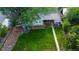 Expansive backyard featuring a well-maintained lawn, mature trees, and a cozy deck area at 3018 S Cherry Way, Denver, CO 80222