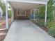 Spacious carport providing covered parking, complemented by well-maintained landscaping and charming home details at 3018 S Cherry Way, Denver, CO 80222