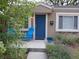 Inviting front porch with blue chairs and a beautifully landscaped garden, perfect for relaxing outdoors at 3018 S Cherry Way, Denver, CO 80222