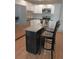 Modern kitchen with stainless steel appliances, center island with seating, and white cabinets at 3018 S Cherry Way, Denver, CO 80222