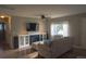 Cozy living room with a fireplace, built-in cabinets, and a large window for natural light at 3018 S Cherry Way, Denver, CO 80222