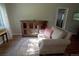 Bright living room features hardwood floors, area rug, comfortable chair and wooden cabinet at 3018 S Cherry Way, Denver, CO 80222