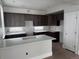 Modern kitchen with dark gray cabinets and white quartz countertops at 6643 W 52Nd Ave # C, Arvada, CO 80002