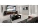 A finished basement area is setup as a home theater, with couch and screen at 9898 Tourmaline Ct, Parker, CO 80134