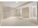Finished basement with carpet flooring, a white door and natural light at 9898 Tourmaline Ct, Parker, CO 80134