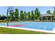 Outdoor basketball court with blue and red surfaces with hoops, and a covered bench area at 9898 Tourmaline Ct, Parker, CO 80134