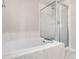 Bathroom featuring a white tiled corner tub and a glass door shower at 9898 Tourmaline Ct, Parker, CO 80134