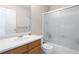 Bathroom with a frosted glass shower door, white vanity and toilet, and neutral wall paint at 9898 Tourmaline Ct, Parker, CO 80134